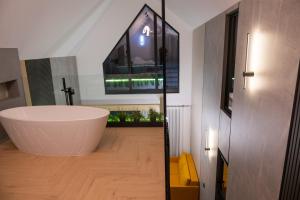 a bathroom with a large tub in the middle of the room at Chalet Port Bicaz in Bicaz +137 photos
