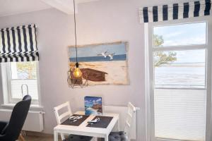 a dining room with a table and a window at Ille in Wittdün