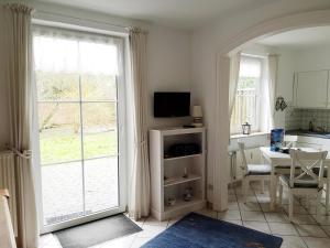 a kitchen and dining room with a large sliding glass door at Hygge in Nebel