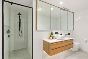 a bathroom with a sink and a shower at Kove Apartment - G03 in Kiama