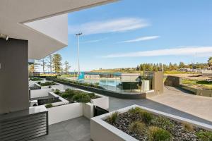 a view from the balcony of a building with plants at Kove Apartment - G03 in Kiama