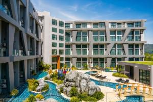 an apartment building with a pool and a resort at Duplex Loft 5 Pools and Gym near Nai Harn Beach- UTL B119 in Rawai Beach