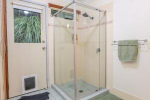 a shower with a glass door in a bathroom at Serenity Rainforest Retreat With Breathtaking Gold Coast Views - Sleeps 4 - 6 people in Springbrook +41 photos