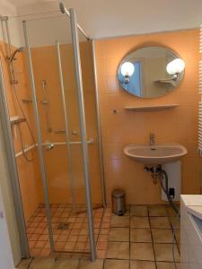 a bathroom with a shower and a sink at HaK-3 in Wittdün