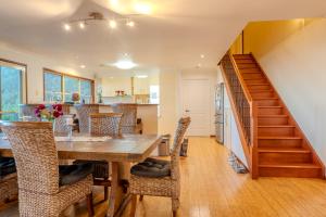 a kitchen and dining room with a wooden table and chairs at Serenity Rainforest Retreat With Breathtaking Gold Coast Views - Sleeps 4 - 6 people in Springbrook