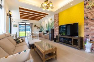 a living room with a couch and a tv at 50 Lan House in Yilan City +39 photos