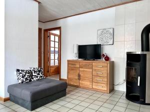 a living room with a couch and a flat screen tv at Tiramisu in Wittdün