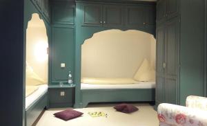 a childs bedroom with a bed in a green room at Eismoewe in Nebel
