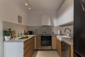 a kitchen with a sink and a stove top oven at Seafront Escape - 4BR Beachfront Villa for 8 in Šibuljina