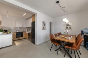 a kitchen and dining room with a table and chairs at Seafront Escape - 4BR Beachfront Villa for 8 in Šibuljina