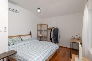 a bedroom with a bed and a desk and a closet at Seafront Escape - 4BR Beachfront Villa for 8 in Šibuljina +28 photos