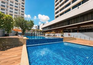 a swimming pool in front of a building at Impiana Hotel Ipoh in Ipoh
