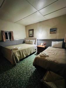 a hotel room with two beds and a couch at room #2 Rancho Meling in Camalú