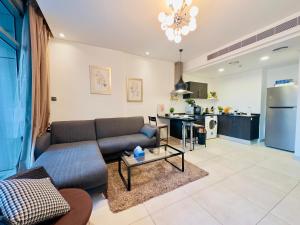a living room with a couch and a table at Sea View Apartment in Era View in Manama