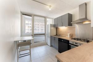 a kitchen with a sink and a stove top oven at A350 Suites - Appartement climatisé, 2 chambres in Colomiers