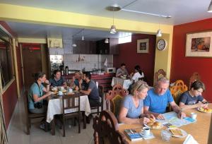 a group of people sitting at tables in a restaurant at Andenes Puno in Puno