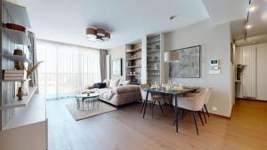 a living room with a table and a couch at Eurovea Tower Apartments free Parking in Bratislava