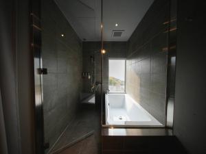 a bathroom with a bath tub and a shower at Over the MOON in Awaji +49 photos