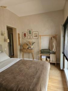 a bedroom with a bed and a table and a chair at PineHills in Mărişel