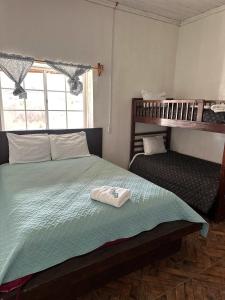 a bedroom with a bed with a towel on it at Casa Lizany in Camalú