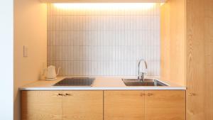 a kitchen with a sink and a counter top at ジローズガーデン in Ishinomaki