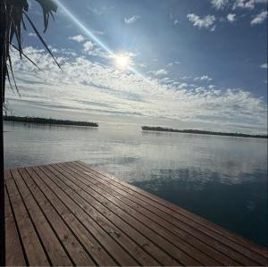 a view of a body of water with the sun at Faimano Lodge & Car in HUH +1 photo