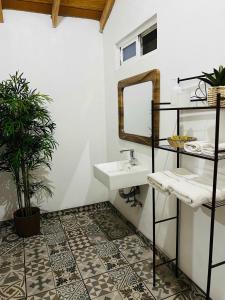 a bathroom with a sink and a mirror at #11- Rancho Meling in Camalú