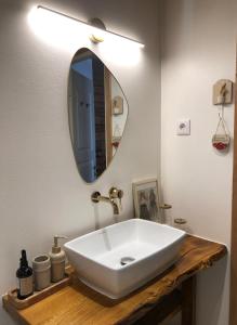 a bathroom with a white sink and a mirror at Rohu Külaliskorter vanalinnas in Kuressaare +11 photos