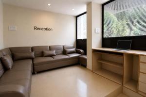 a living room with a couch and a television at MogPrach Boutique in Calangute