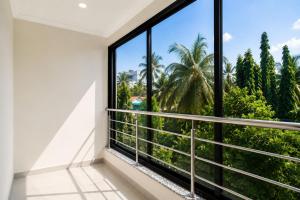 a room with a large window with a view at MogPrach Boutique in Calangute