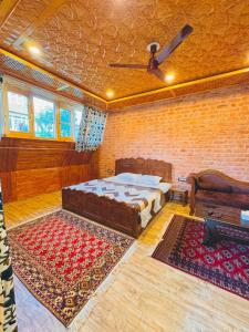 a bedroom with a bed and a brick wall at French Woods Cottages in Srinagar