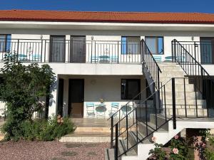 a house with a staircase leading to a balcony at Vila Elna in 2 Mai