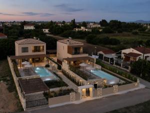 an aerial view of a house with two swimming pools at Ora Blu Villas in Mytikas