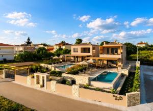 an aerial view of a house with a swimming pool at Ora Blu Villas in Mytikas