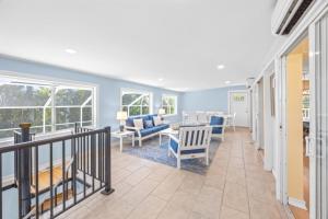 a living room with blue walls and a balcony at Murmond- Captiva Home in Captiva