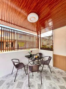 a dining room with a table and two chairs at Casa de Villanueva in Davao City