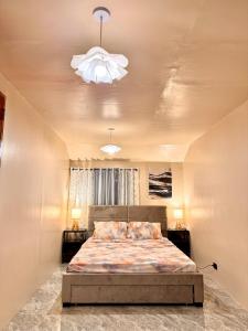 a bedroom with a bed and two night stands at Casa de Villanueva in Davao City