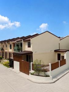 a house with a fence in front of it at Casa de Villanueva in Davao City