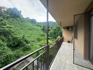 a balcony with a view of a mountain at Luso in Batumi