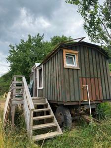 a green truck with a tiny house on it at Britania Hobbit in Predeluţ