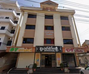 a building with a sign in front of it at Manipal Downtown in Manipal +12 photos