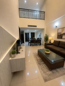 a living room with a couch and a table at Anjung Seri Residence in Masai