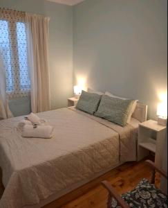 a bedroom with a bed with a towel on it at Lefkada Old Town Kantouni in Lefkada