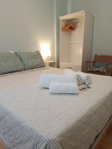 a white bed with towels on top of it at Lefkada Old Town Kantouni in Lefkada
