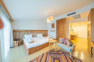 a bedroom with a bed and a table and a couch at Harbour Suites Fethiye in Fethiye +44 photos