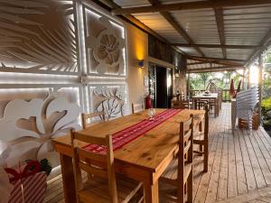 a wooden table and chairs on a patio at La Cabane D Eté in Port Mathurin