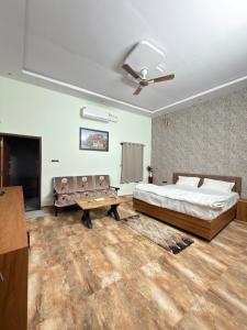a bedroom with a bed and a ceiling fan at Nova Heaven Villa in Daijar +20 photos