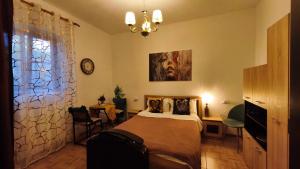 a bedroom with a bed and a table and a clock at Confort Flat in Braşov