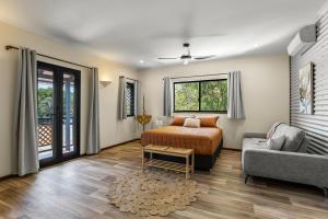 a bedroom with a bed and a couch at The Courthouse Bed & Breakfast in Broome +39 photos