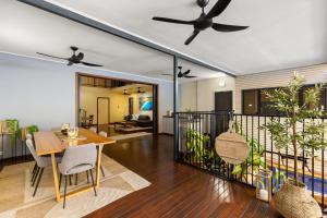 a dining room and living room with a ceiling fan at The Courthouse Bed & Breakfast in Broome